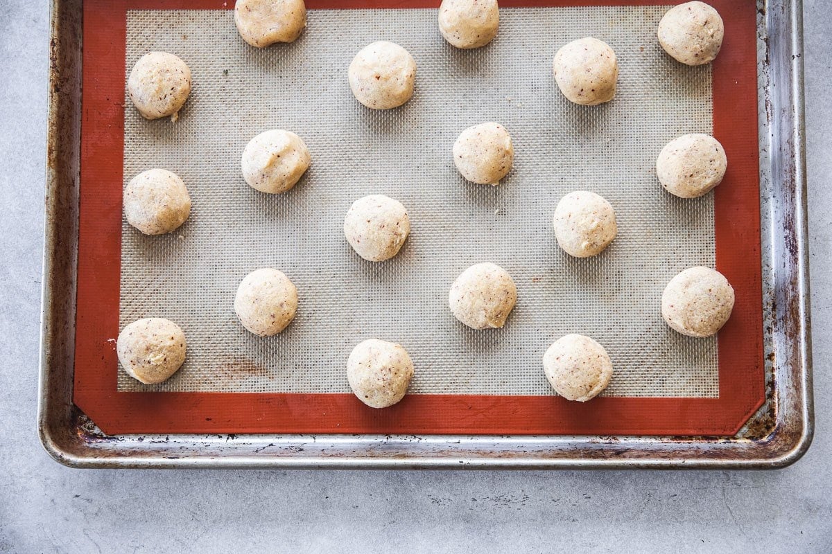 Roll jam drop cookies in golf-ball sized rounds and place on a baking sheet lined with baking paper or silicone.