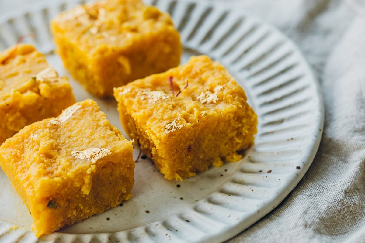 Serve mango barfi squares straight from the fridge or warm up for 10 seconds in the microwave.