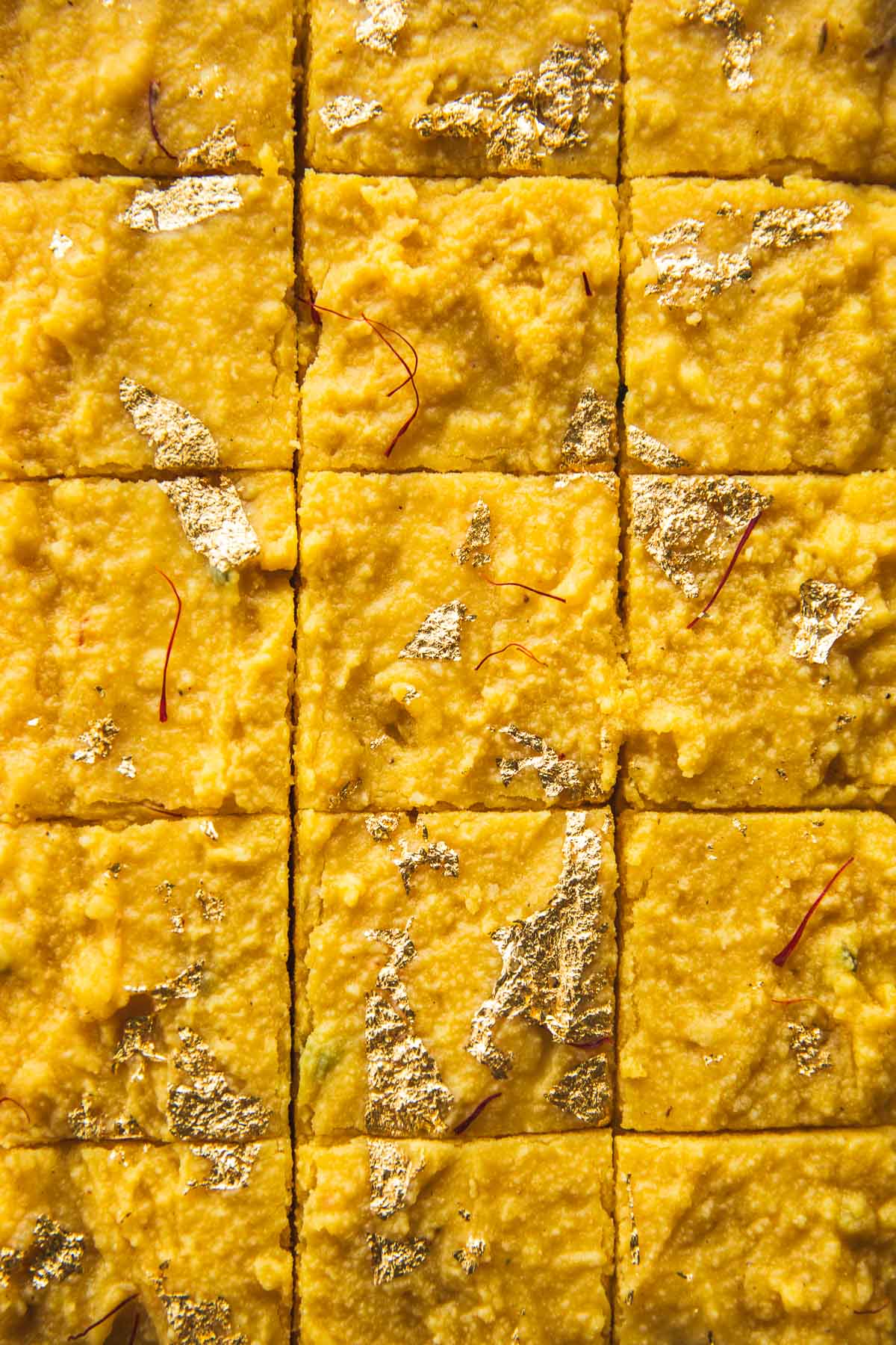 Microwave Mango Barfi topped with gold leaf and cut into squares.