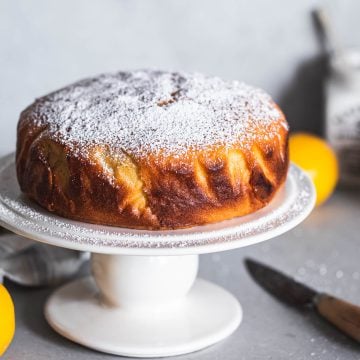 Baked Lemon Cake With Icing Sugar on a cake stand