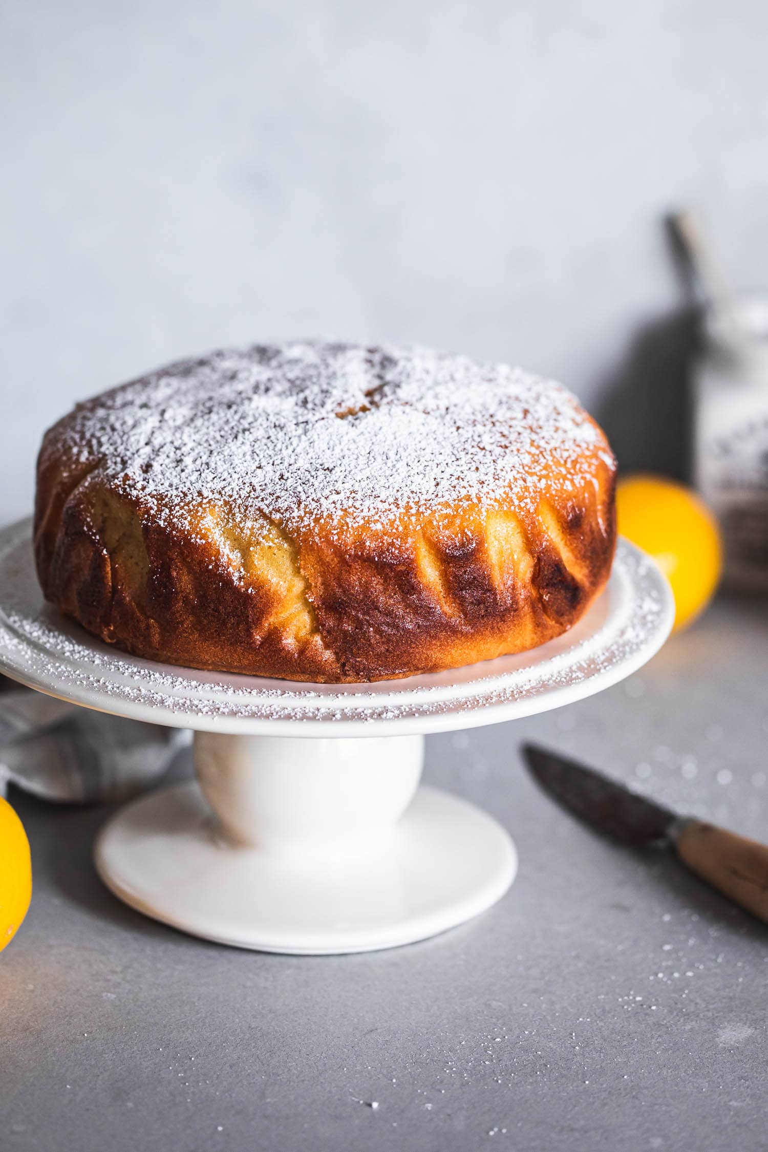 Baked Lemon Cake With Icing Sugar on a cake stand
