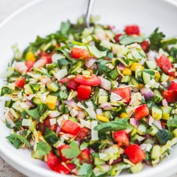 Kachumber Salad in a bowl with a spoon.