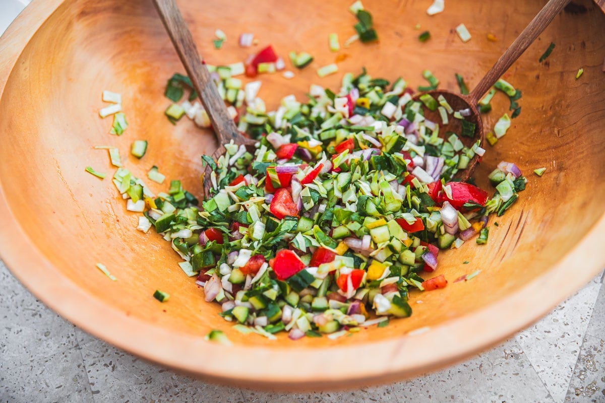 Mix all ingredients for Kachumber Salad in a large bowl.