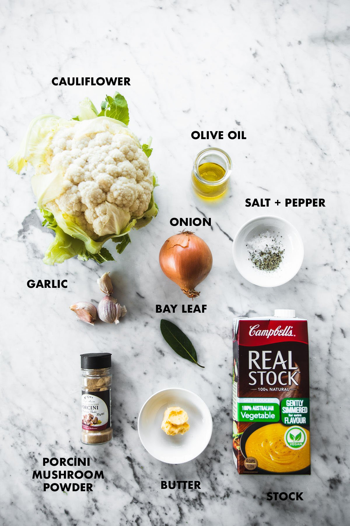 Roasted Cauliflower Soup Ingredients labeled on a white marble table.