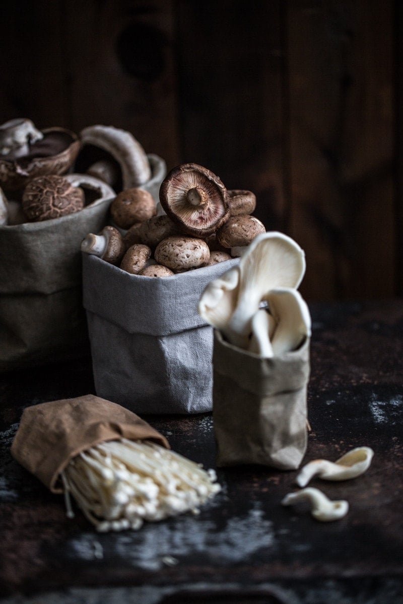 Different mushroom varieties - enoki, oyster, shiitake, Swiss Brown and white cup mushrooms.