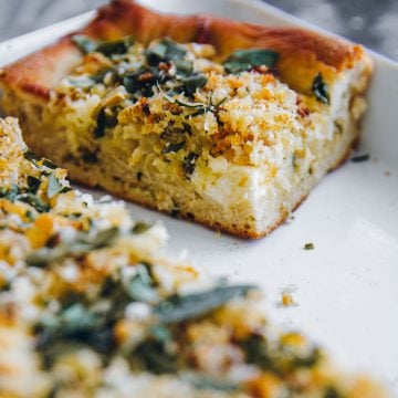 A square slice of Roasted Cauliflower Grandma Pie in a white tray.