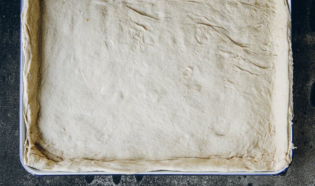 Line the rolled dough in a shallow baking tray.