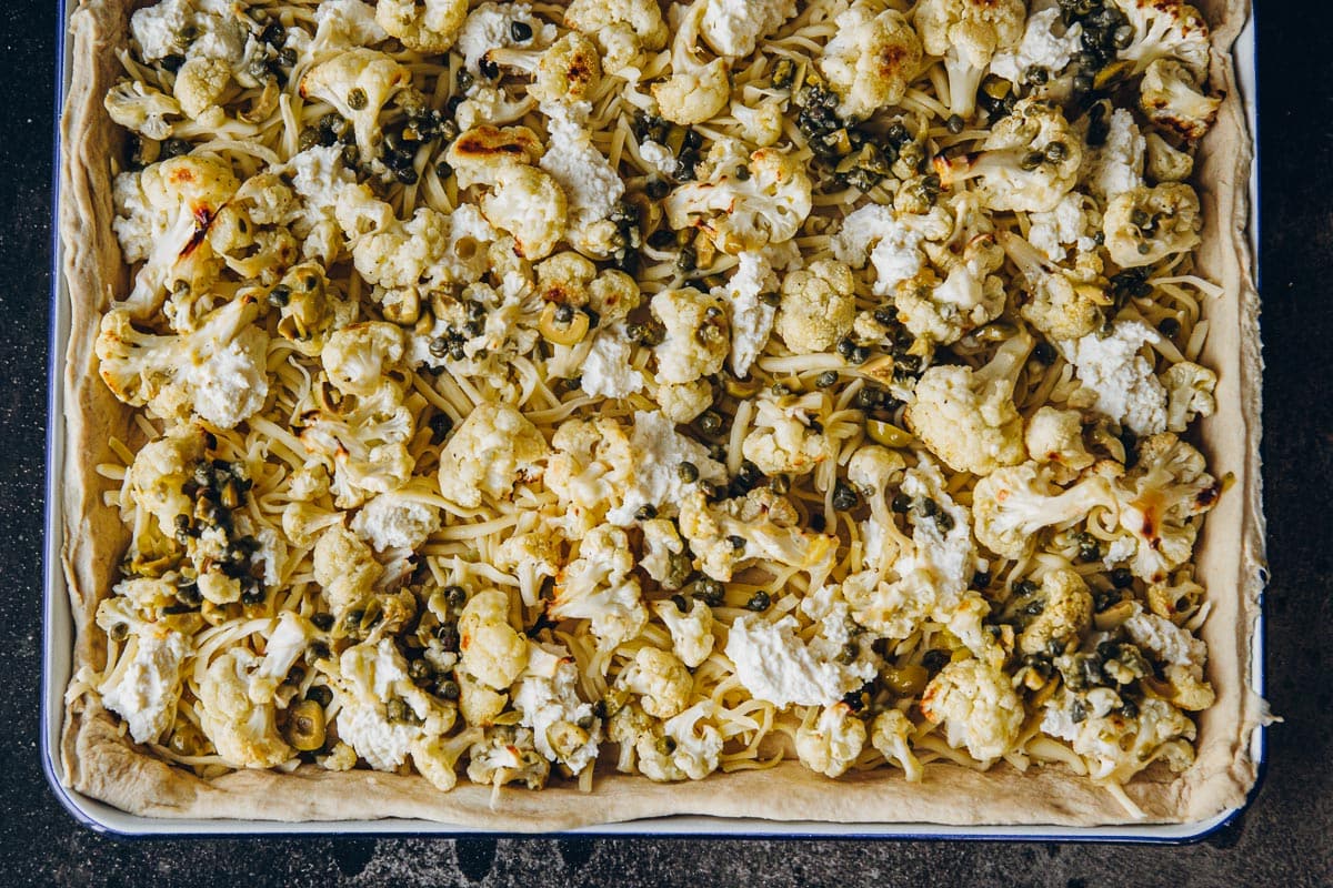 Add the roasted cauliflower topping and bake.