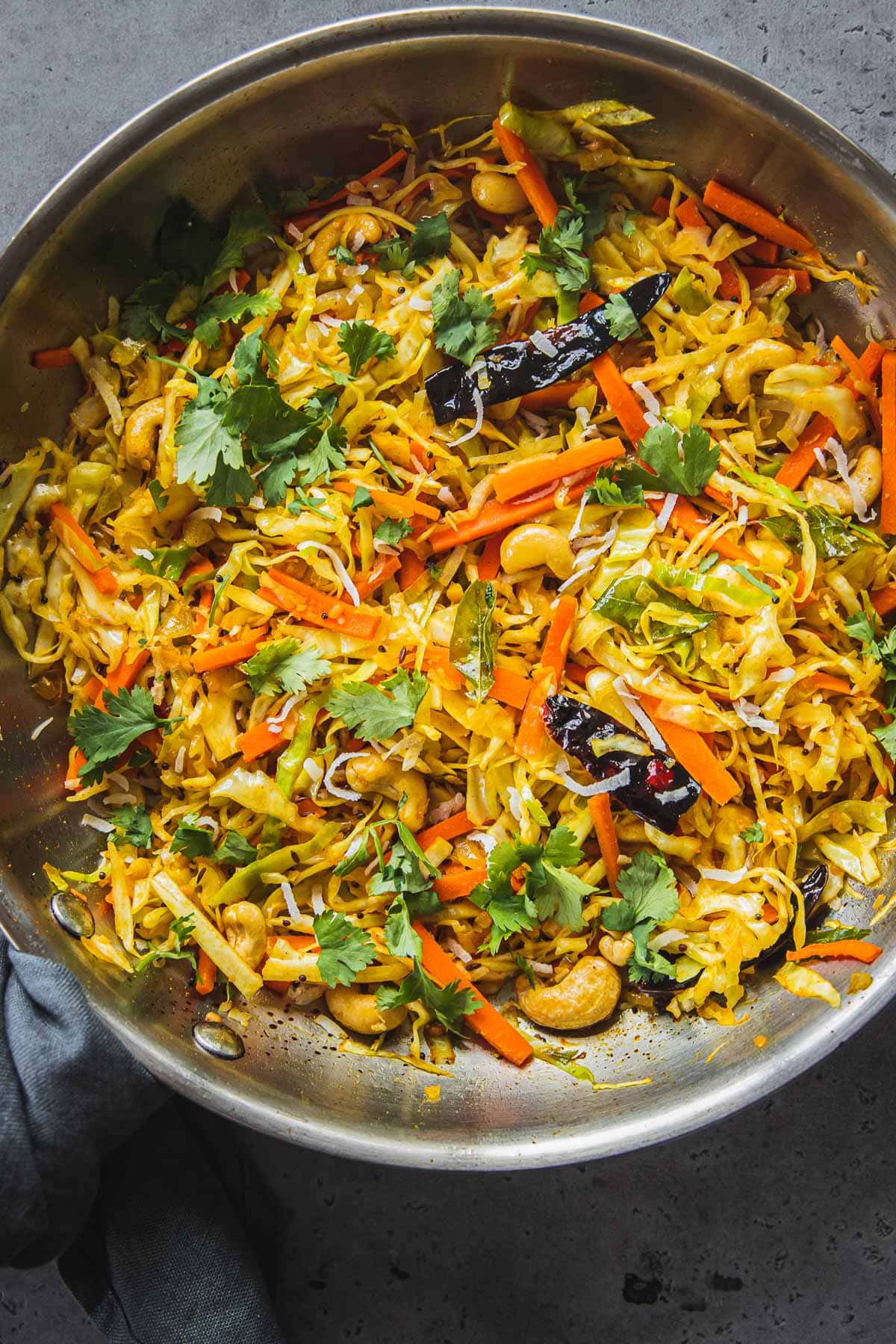 Cabbage Thoran in a large stainless steel frying pan.