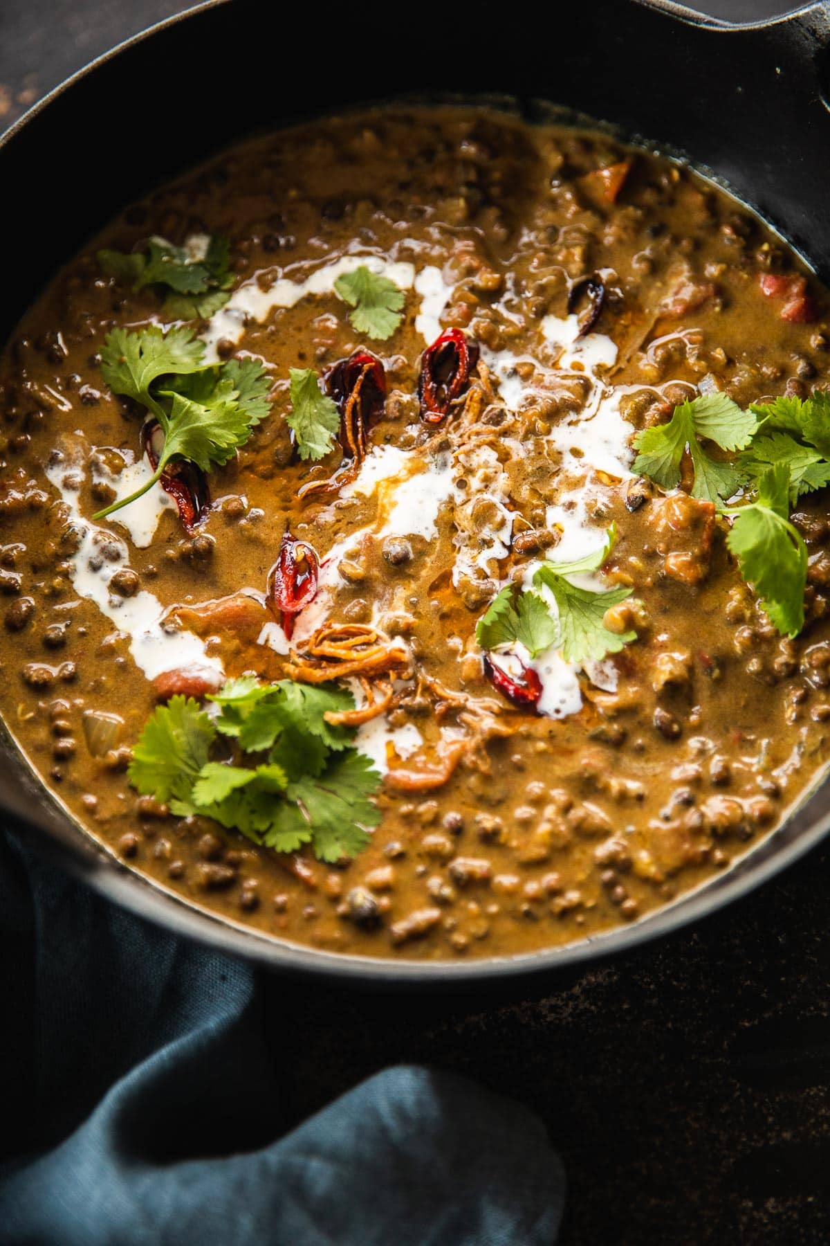 Vegan Dal Makhani with a tarka on top and garnished fresh coconut cream and coriander.