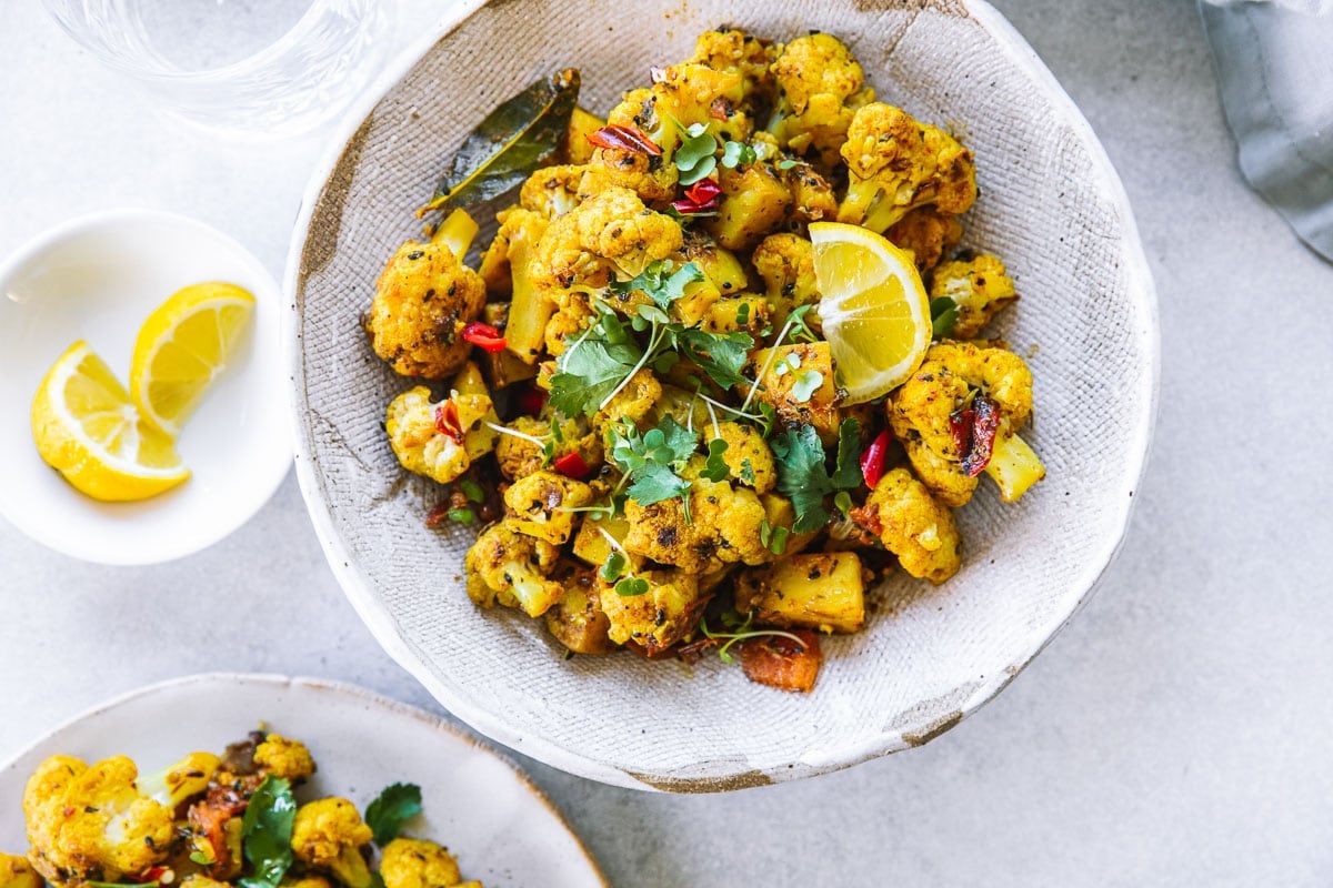 A bowl of yellow turmeric-infused potato and cauliflower curry from Northern India - aloo gobi.