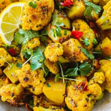 Close up of Aloo Gobi - a dry Indian curry made of potato, cauliflower and spices