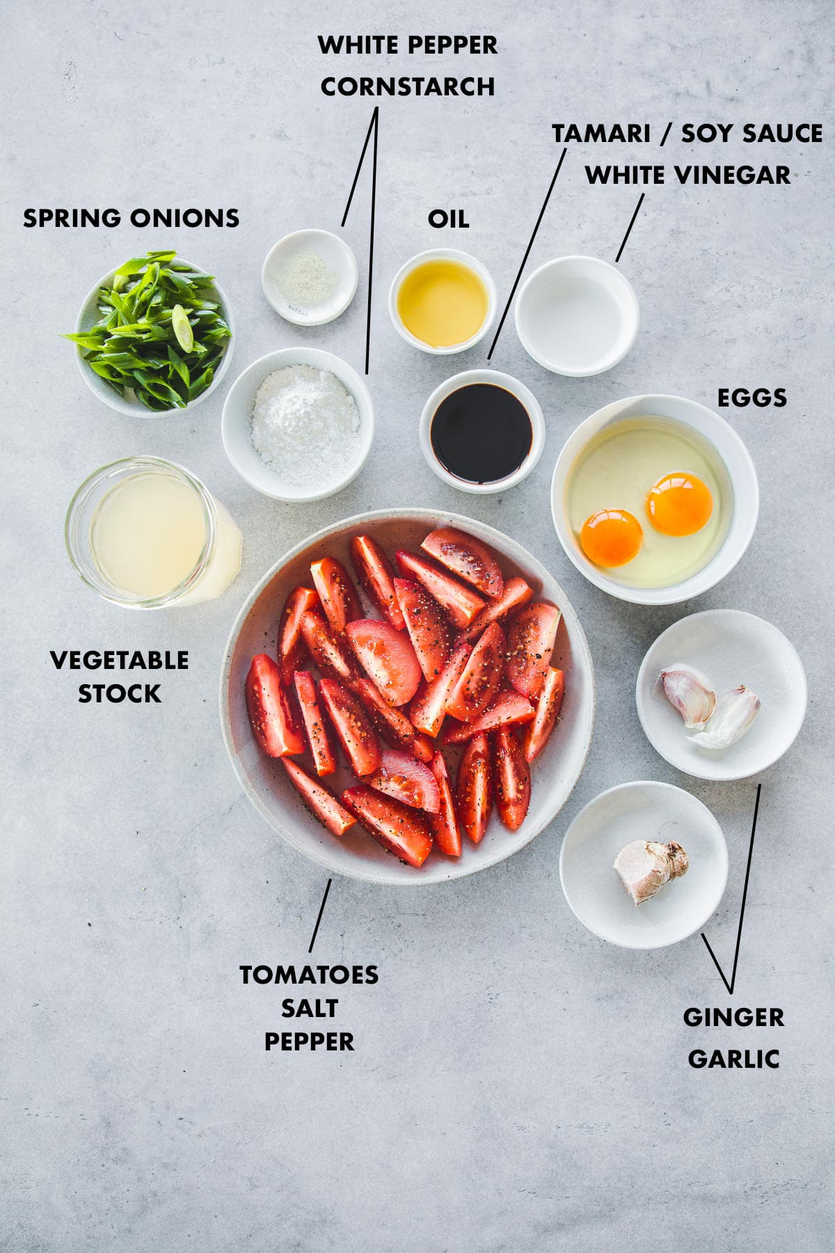 Ingredients for Egg Drop Soup measured in bowls and labeled.