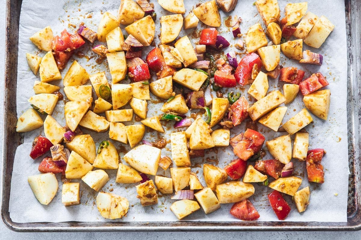 Spread Aloo Palak mixture on a large rimmed baking sheet lined with baking paper.