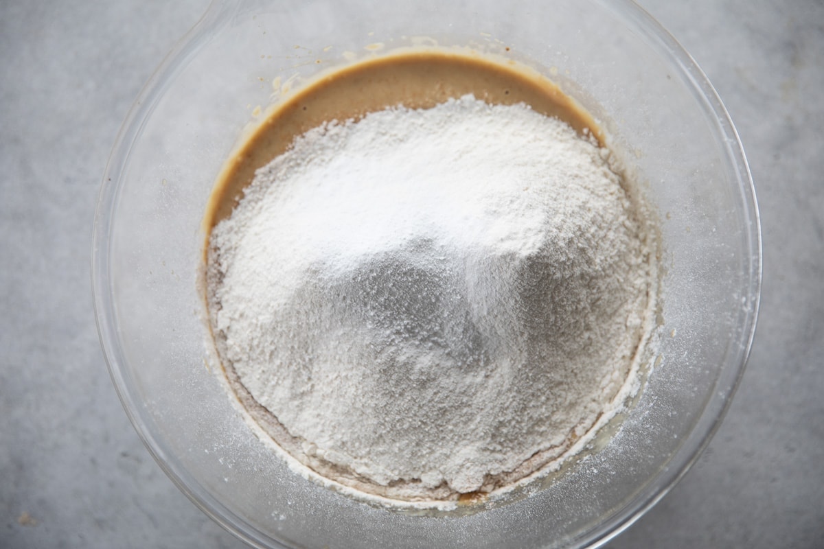 Step 5 - Add flours, baking powder and baking soda to the wet mixture. Whisk for a few seconds until just combined.