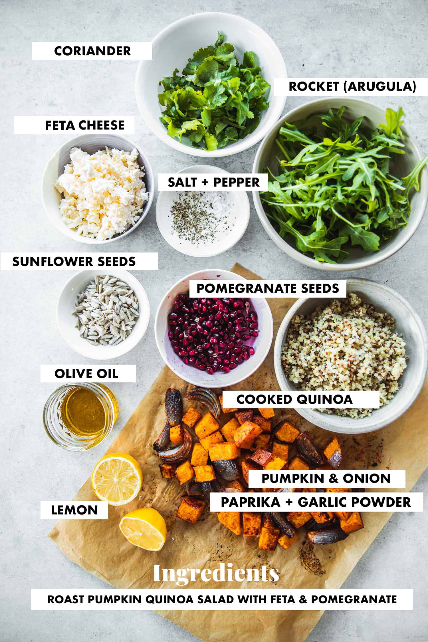 Ingredients for Roast Pumpkin Quinoa Salad measured in bowls - Roast pumpkin, cooked quinoa, feta cheese, pomegranate seeds, sunflower seeds, rocket, coriander, salt, pepper, lemon juice and olive oil.