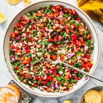Texas Caviar (Cowboy Caviar) served in a bowl with corn chips and margarita