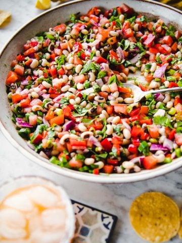 Texas Cowboy Caviar served in a large platter with corn chips