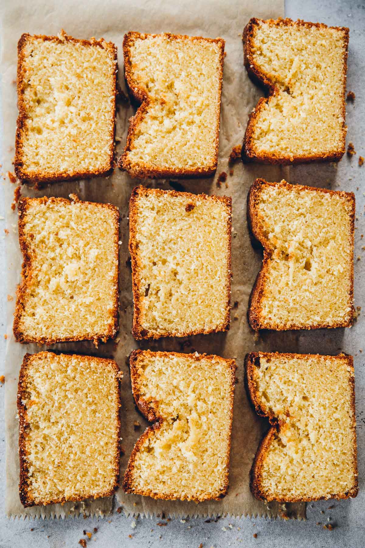 Slices of cooled Lemon Madeira Cake on a paper bag.