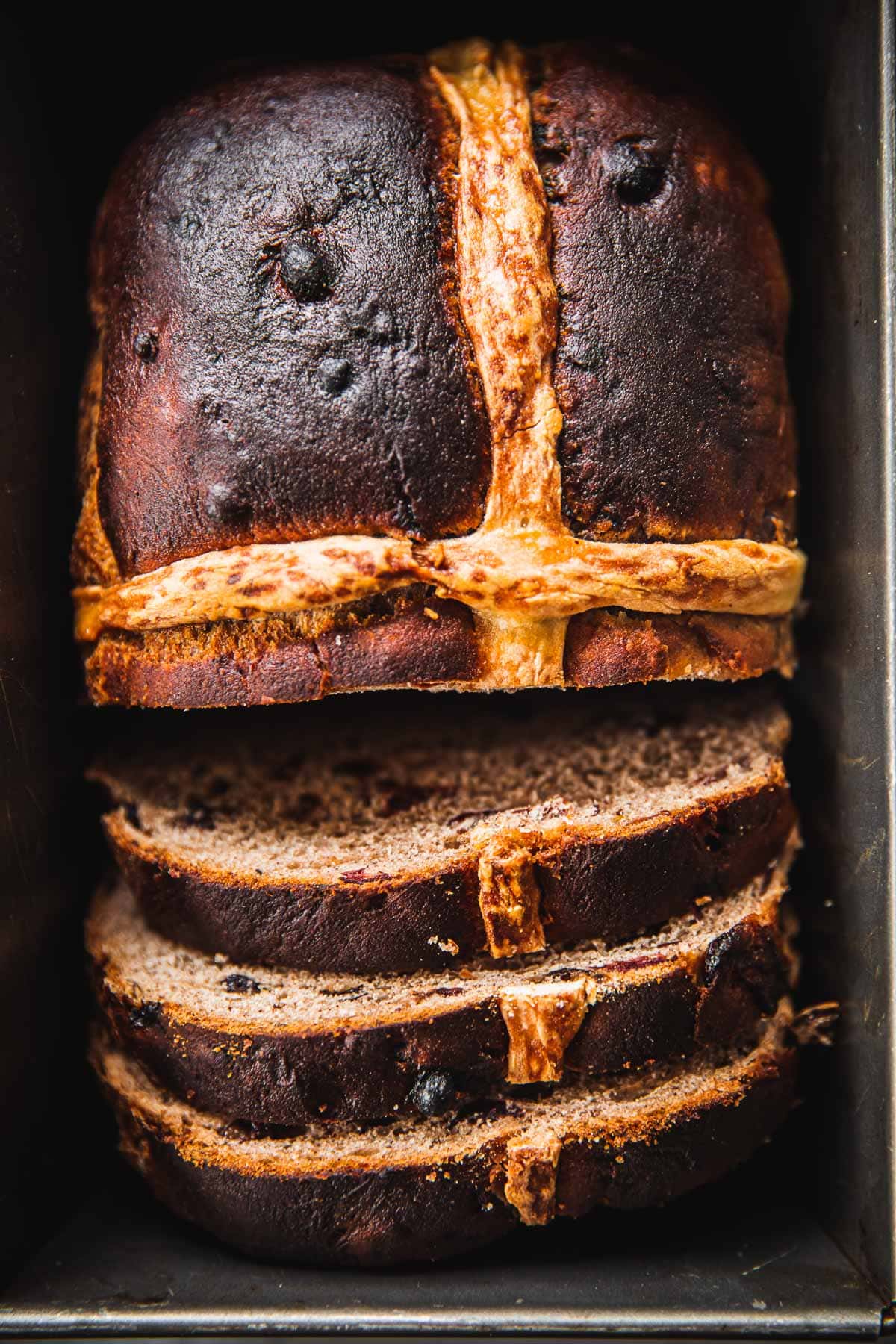 Hot Cross Bun Loaf slices in a baking tin.