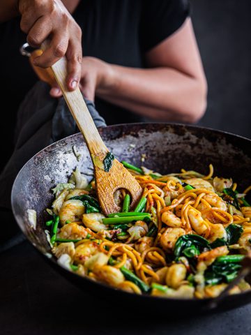 Prawn Hokkien Noodles being stir-fried in a wok.