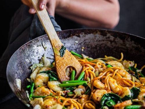 Prawn Hokkien Noodles being stir-fried in a wok.