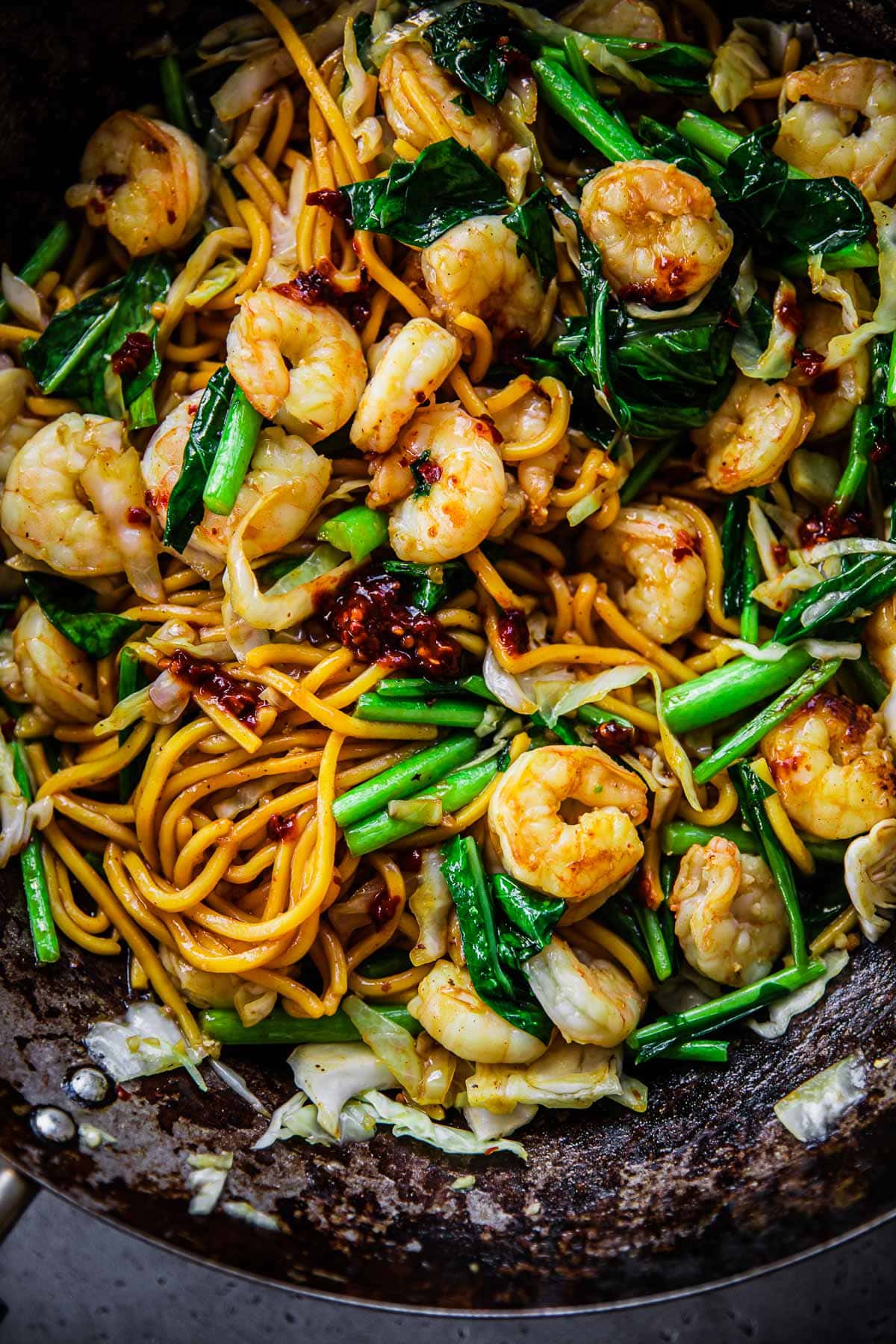 Prawn Hokkien Noodles in a wok topped with spicy chilli paste.