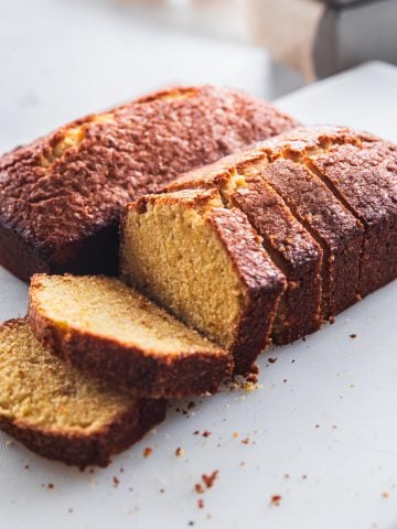 Orange Pound Cake loaves on a white table.