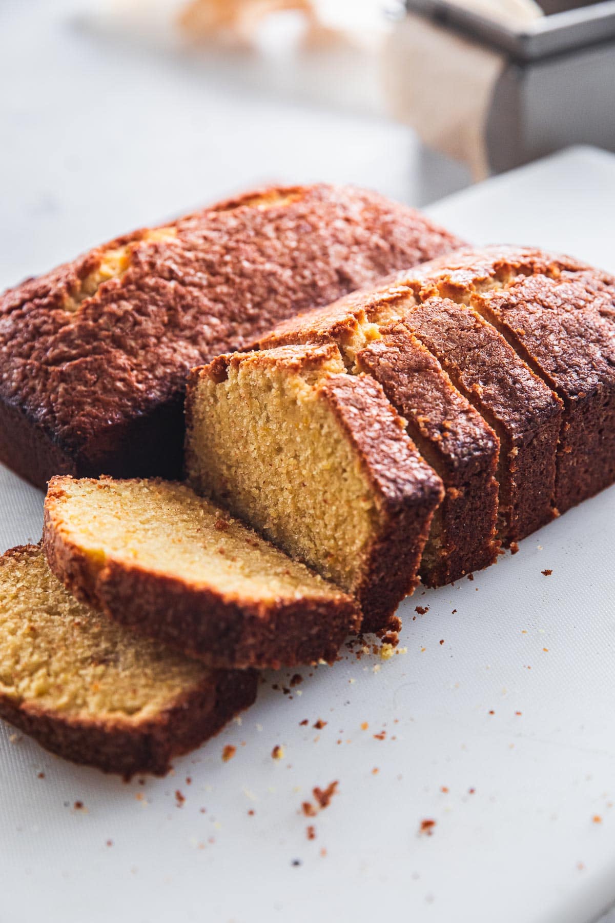 Orange Pound Cake loaves on a white table.