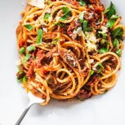 Sardine pasta in a white bowl with a fork.