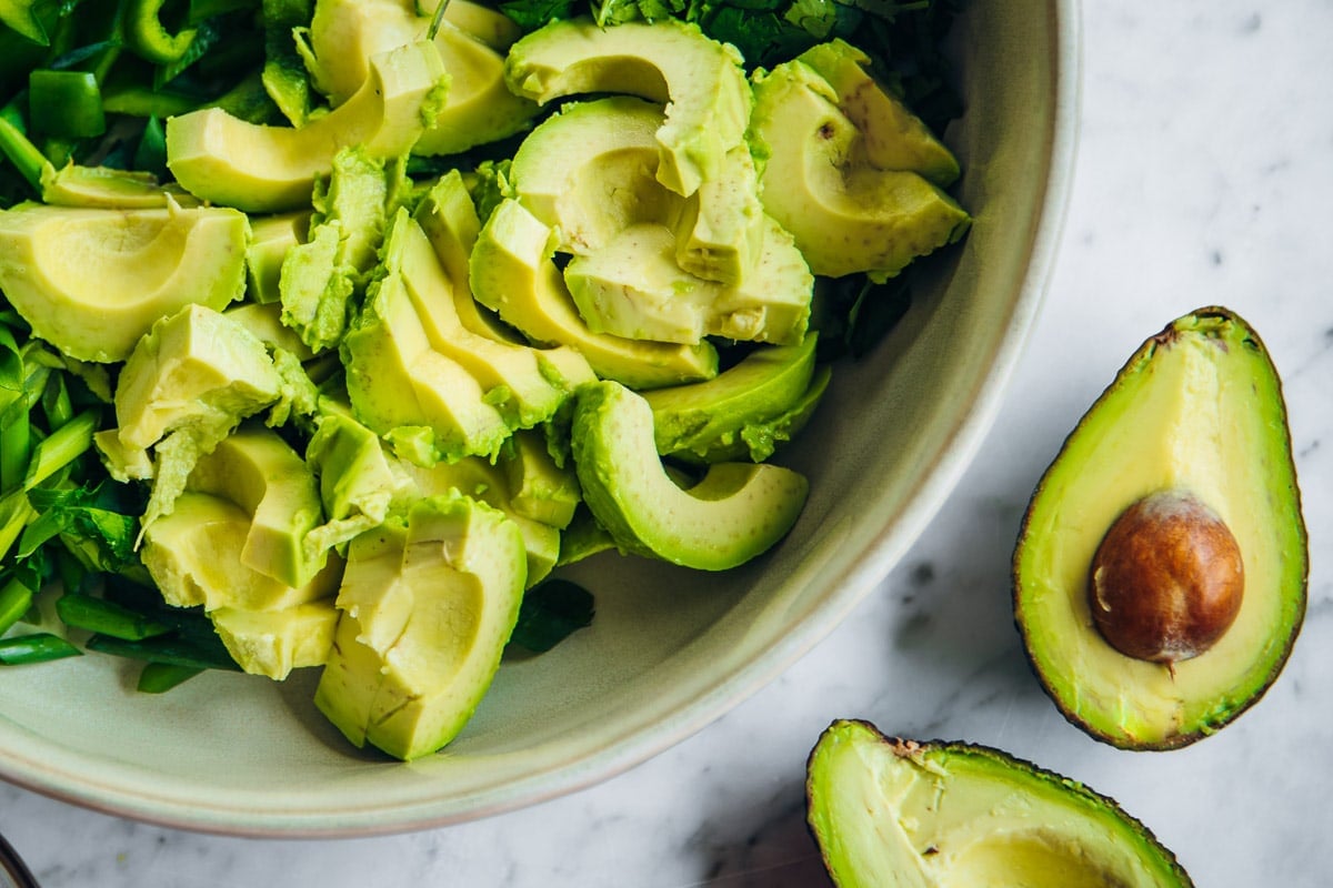 Cut avocado halves into slices and scoop out slices with a spoon.