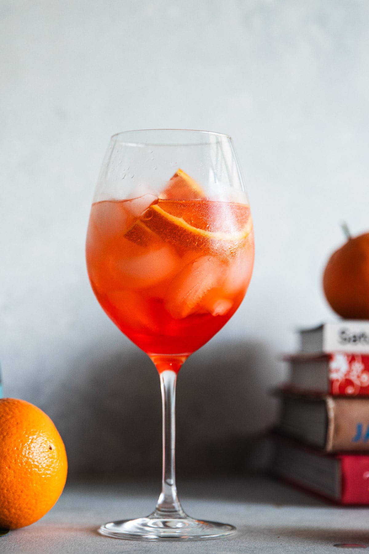 Aperol Spritz in a stemmed wine glass on the kitchen counter.