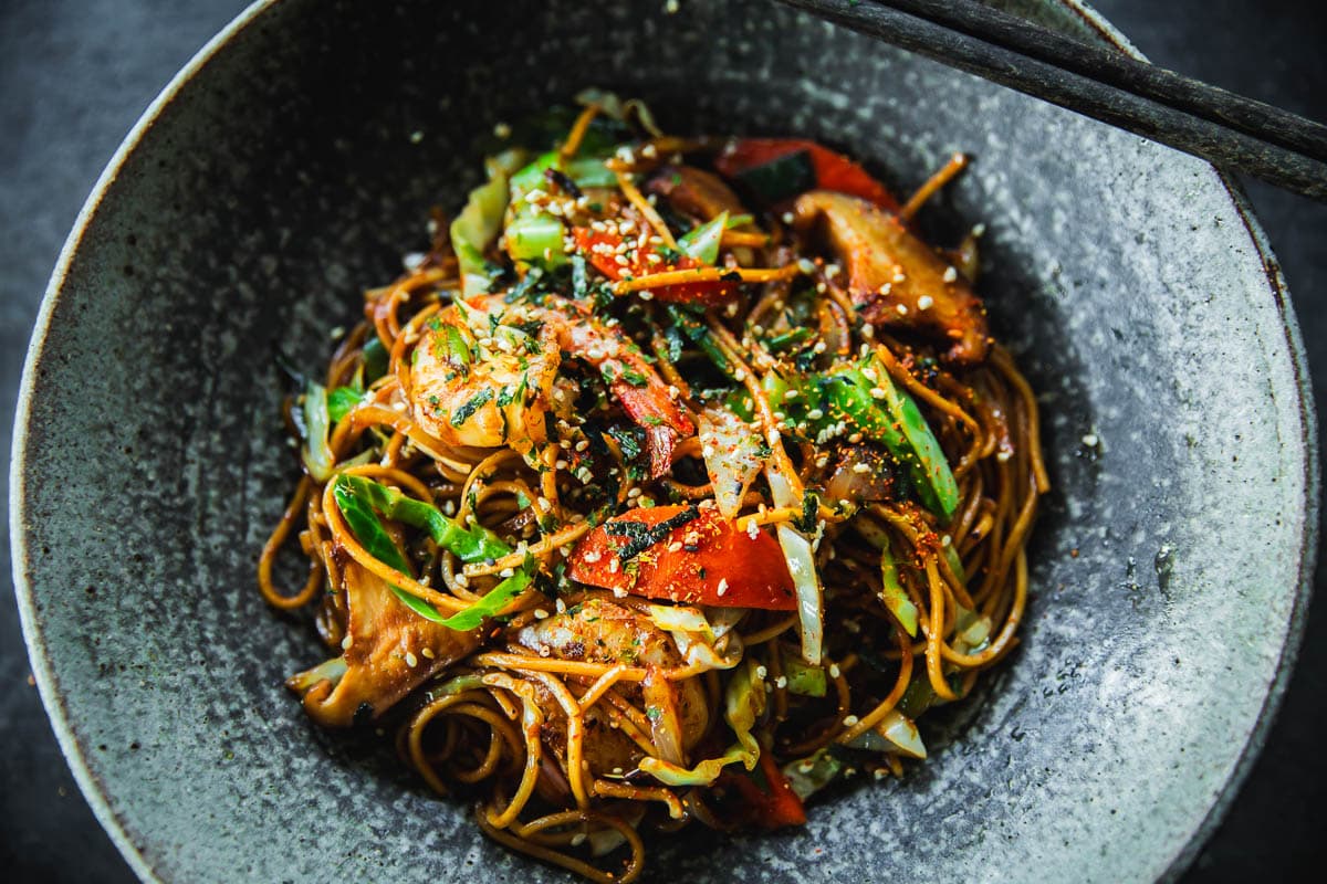 Prawn Yakisoba served in a bowl with chopsticks.