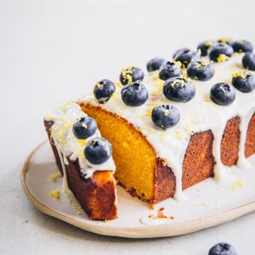 Blueberry Lemon Loaf Cake With Yoghurt Icing and fresh blueberries.