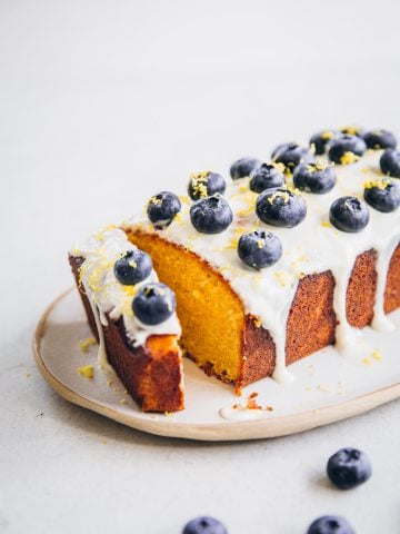 Blueberry Lemon Loaf Cake With Yoghurt Icing and fresh blueberries.