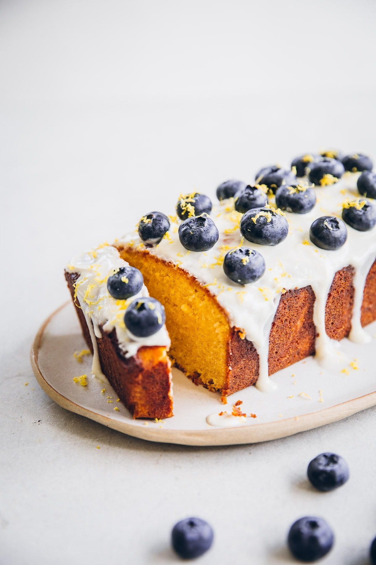 Blueberry Lemon Loaf Cake With Yoghurt Icing and fresh blueberries.