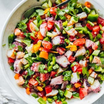 Pipiranna - Spanish Seafood Summer Salad in a bowl with a linen napkin on the side.