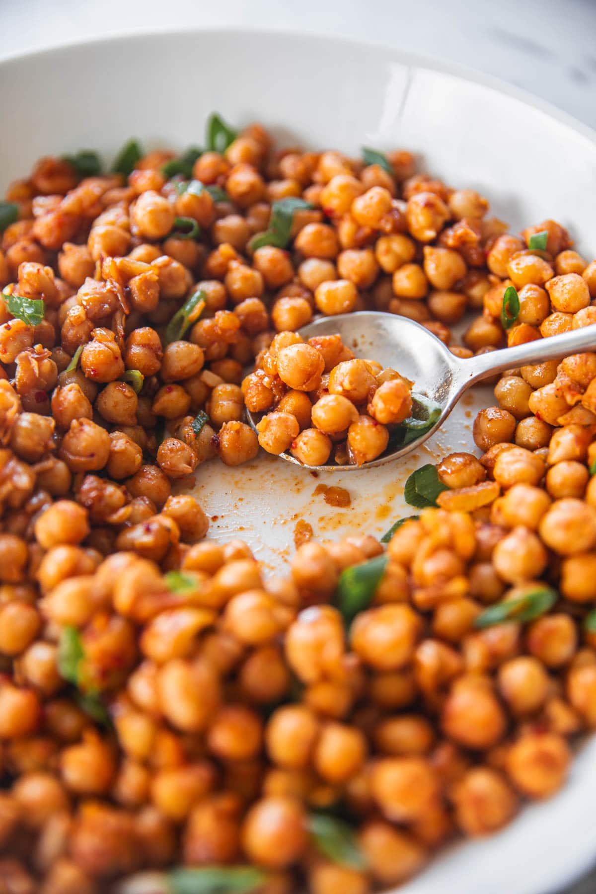 Sauteed Spicy Chickpeas scooped with a sppon.