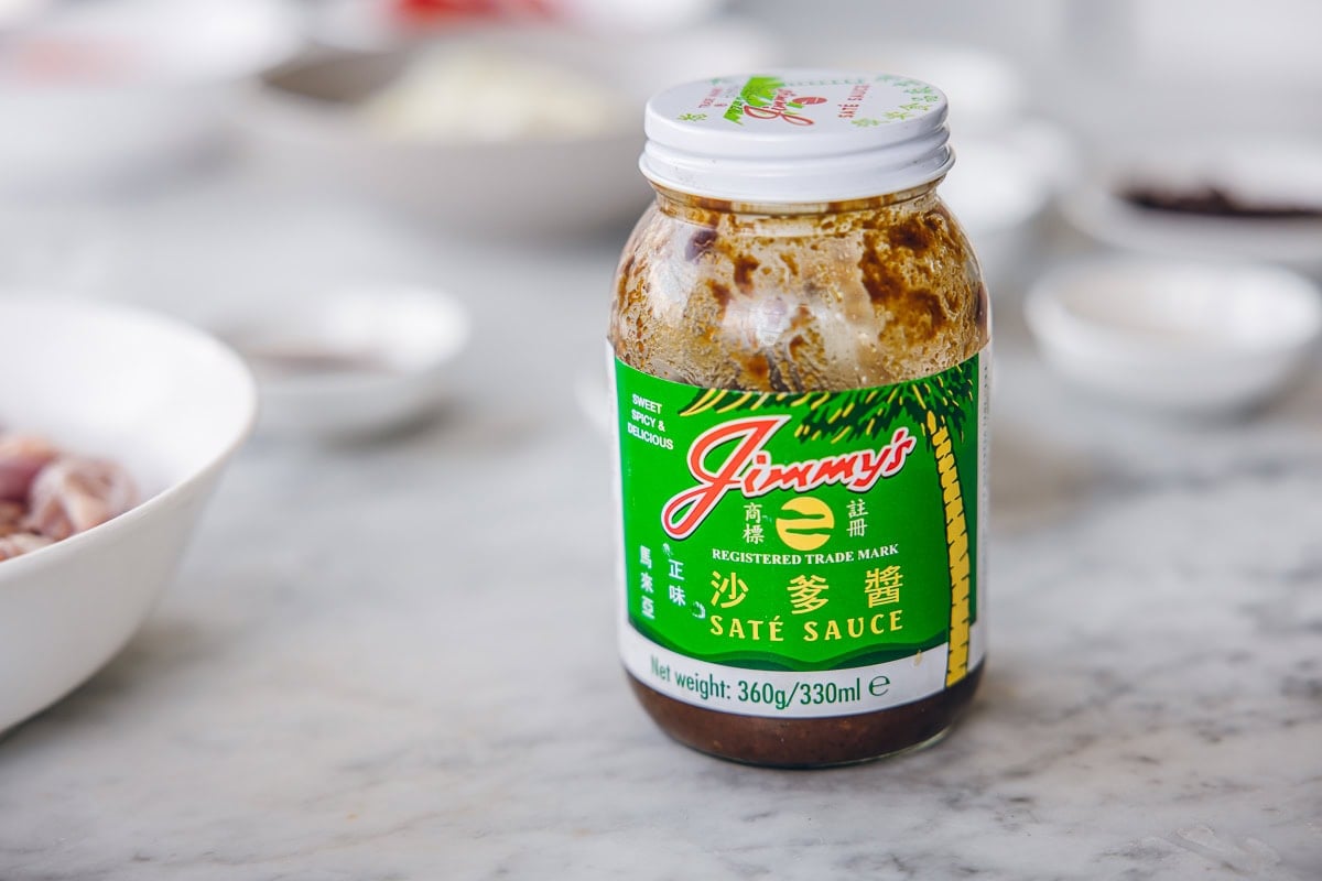 Jar of Jimmy's Sate Sauce on a marble counter.
