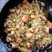 Shrimp And Chicken Fried Rice in a wok with a tea towel around the handle.