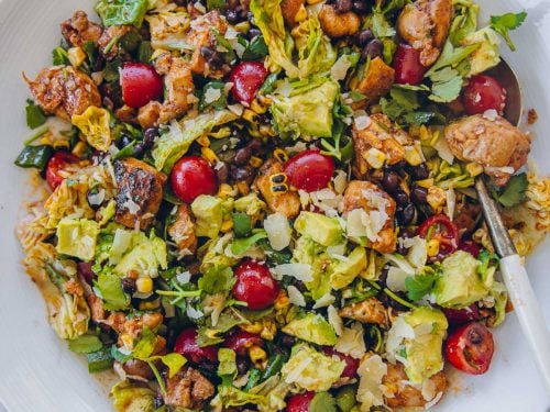 Mexican Chicken Salad in a white bowl with serving spoon.