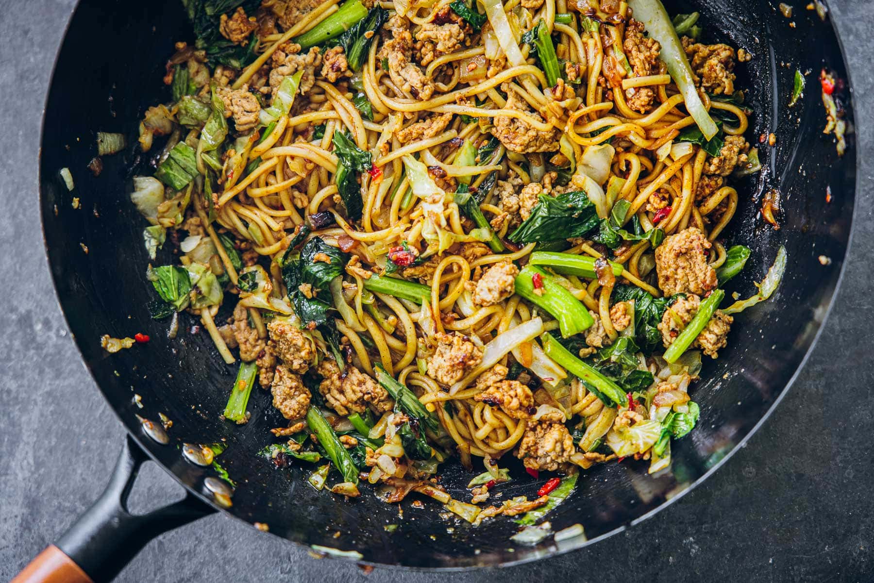 Minced Pork Noodles Stir-fried in a wok.