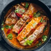 Crispy Salmon in Coconut Lime Sauce in a black pan.